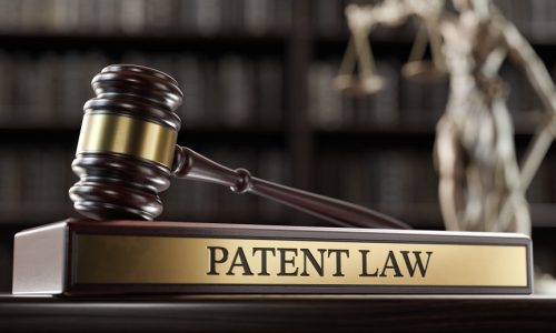 Patent Law: Judge's Gavel as a symbol of legal system and wooden stand with text word