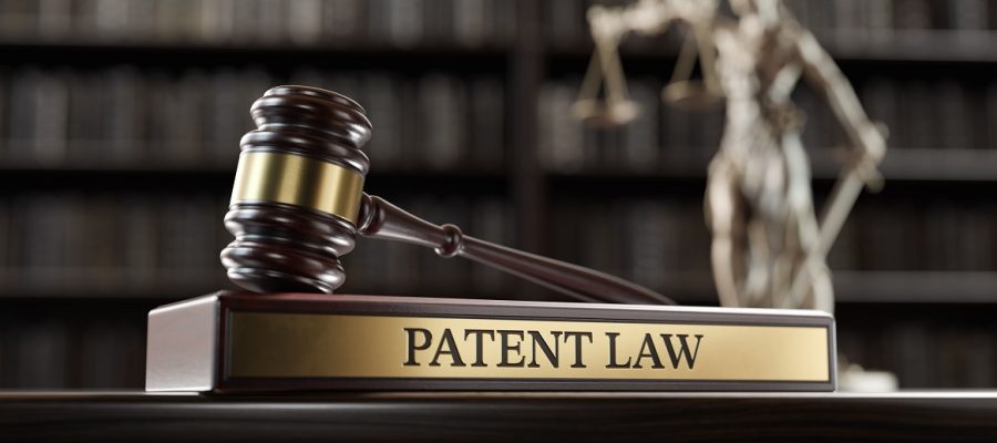 Patent Law: Judge's Gavel as a symbol of legal system and wooden stand with text word